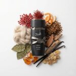 Asad Elixir Lattafa Eau de Parfum Para Hombre con fondo de ingredientes